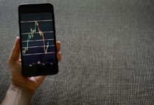 a person holding a cell phone with a chart on it