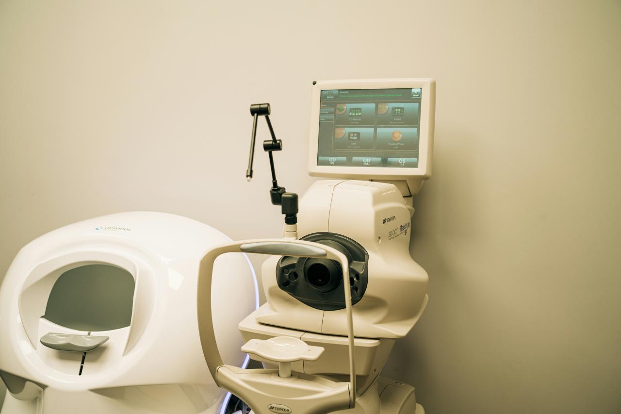 a white toilet with a monitor on top of it